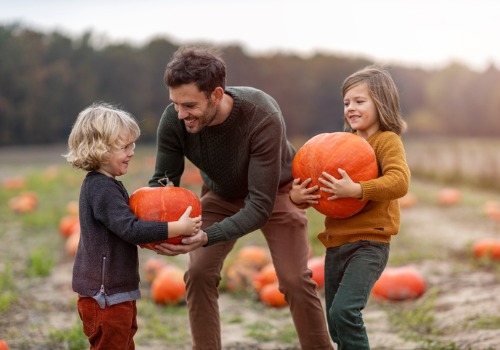 Family picking pumpkins from a Pumpkin Patch for Rock Island IL