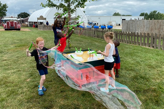 Kids play at a bubble table at Tanners Orchard, which offers Fall Activities for Aurora IL residents