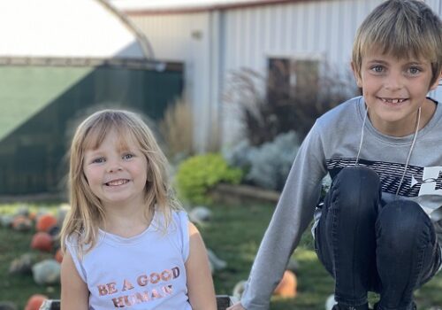 A brother and sister smile at the camera while enjoying all of the Fall Activities for Joliet IL residents that Tanners Orchard has to offer