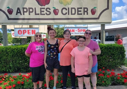 A family poses in front of a sign at Tanners Orchard after searching for Family Fun for LaSalle IL residents