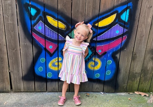 A child smiles in front of a butterfly painting at Tanners Orchard, who also offers a Sunflower Festival for Morton IL residents