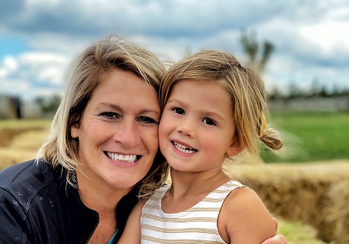 A mom and her daughter smile and pose at Tanners Orchard, which offers numerous Family Activities near Kewanee IL