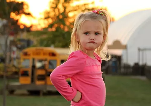 A young girl glares at the camera at Tanners Orchard. If you're asking 